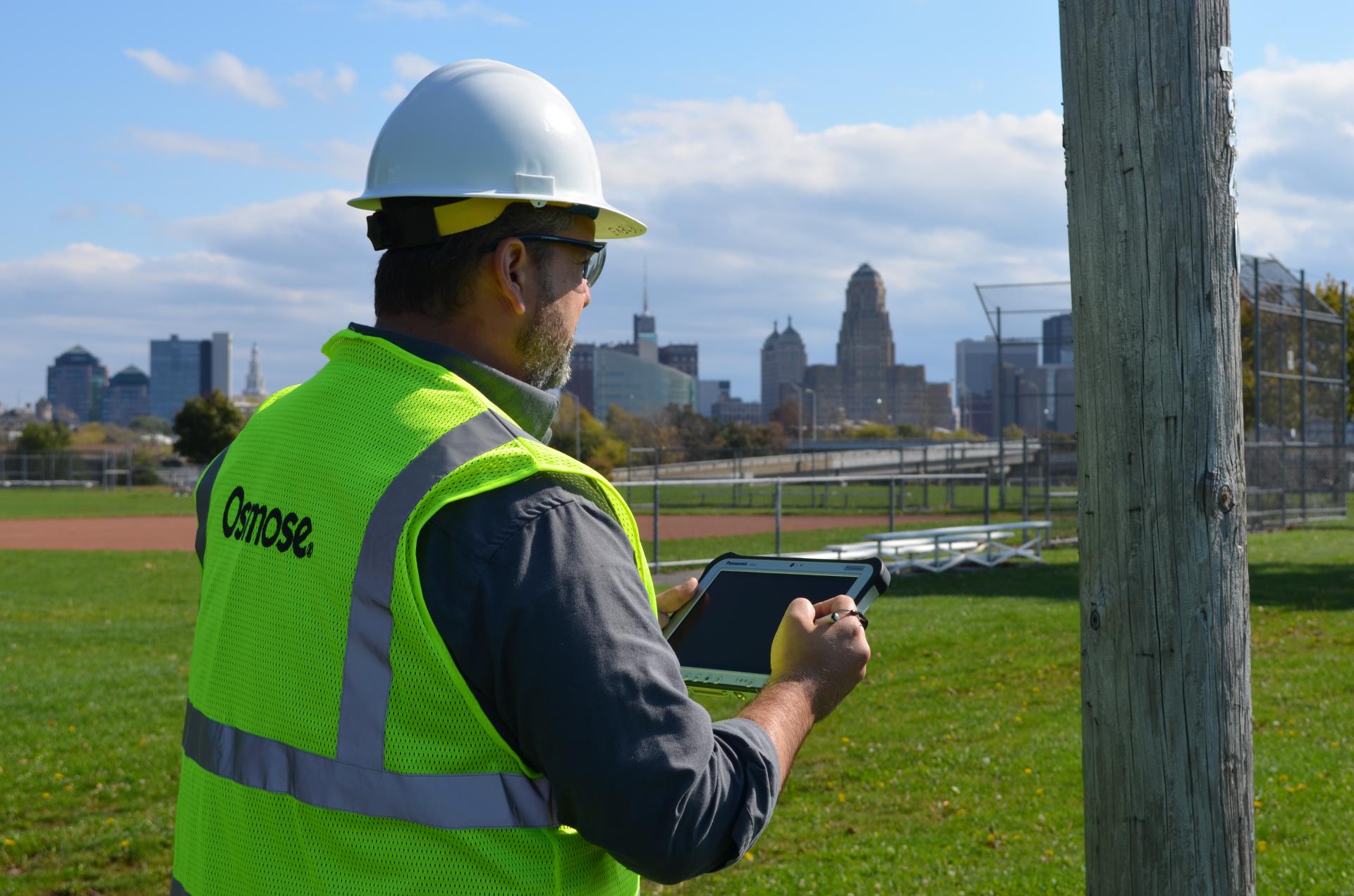 During pole testing, worker evaluating the strength of a utility pole